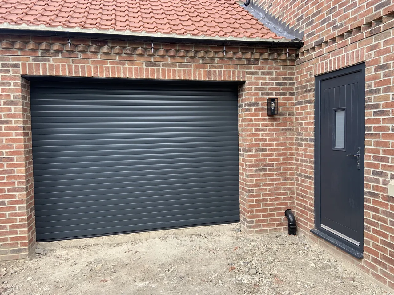 Anthracite garage door and matching side door installed by MG Access