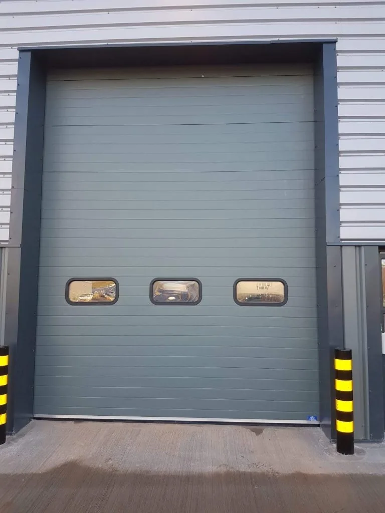 Grey sectional door with a row of three small windows