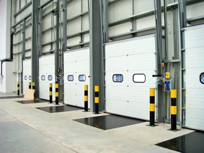 Inside a loading bay with white sectional doors and overhead tracks