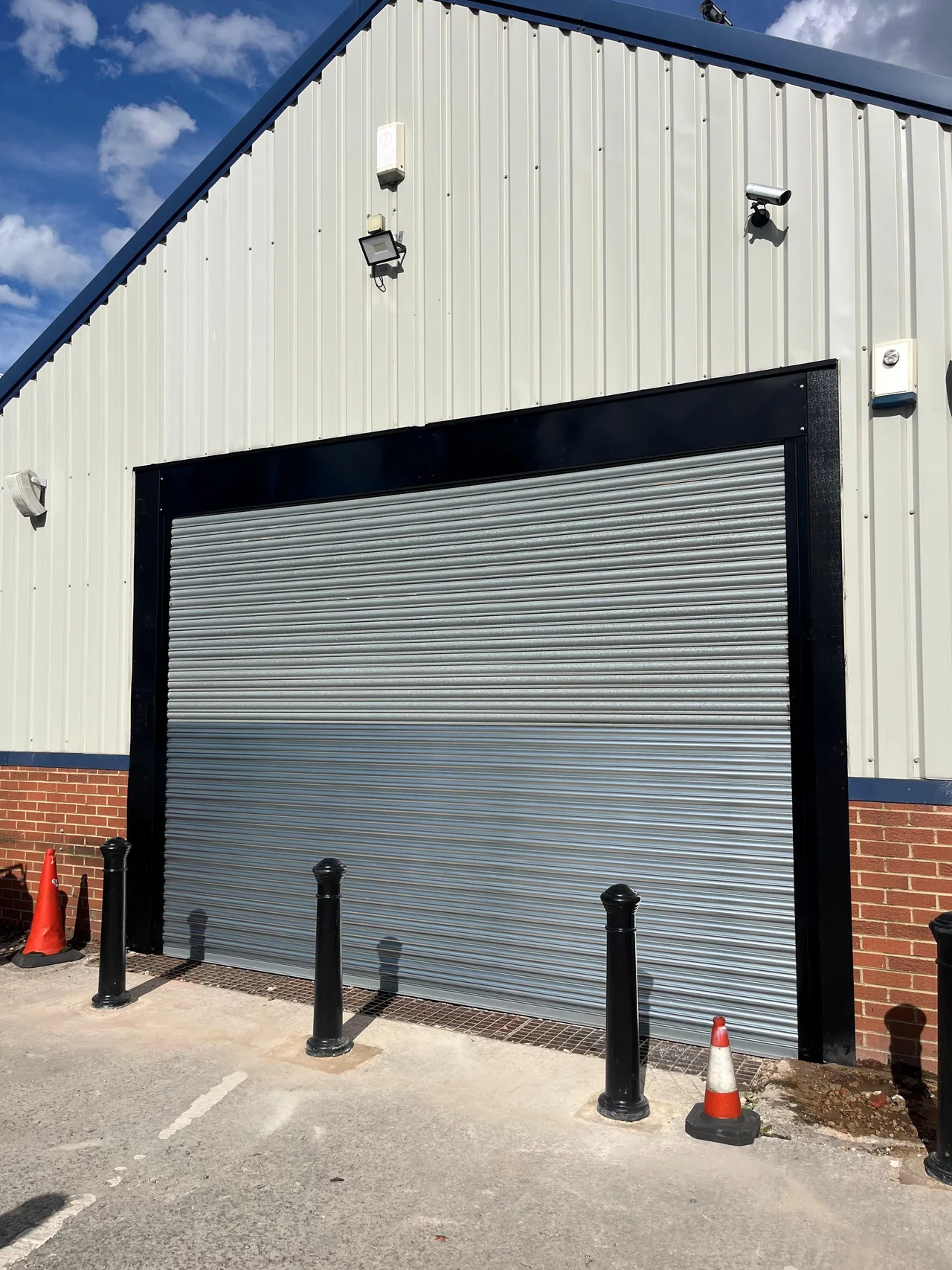 Closed silver roller shutter in a black surround at Jordan’s Bikes.
